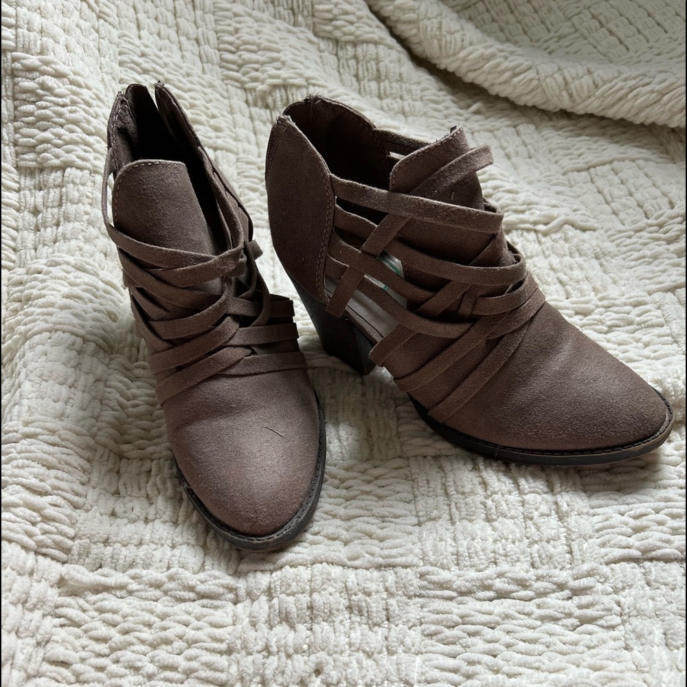 woman’s beige leather boots